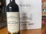 a bottle of wine sitting on a table next to a box of wine