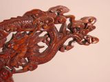 a wooden dragon on the back of a chair