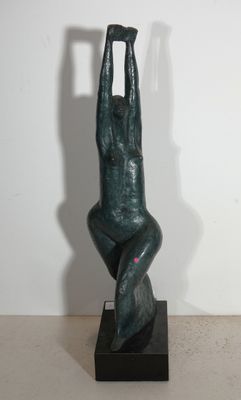 statue of a man on a chair with a shadow on the wall