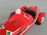 a red toy car with four leaf clovers on the front