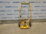 an image of a yellow hand truck with a sign on it