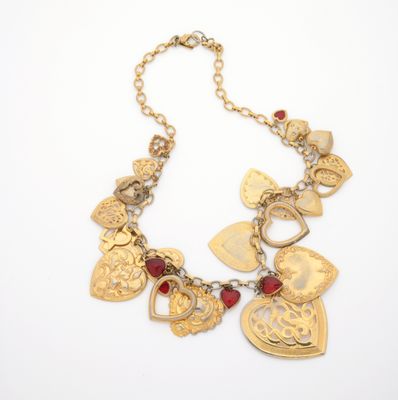 a close up of a necklace on a white surface