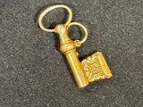an image of a gold key with a keychain on top of it