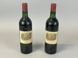 two bottles of wine sitting next to each other on a table