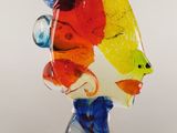 an image of a glass sculpture of a woman ' s face on a base