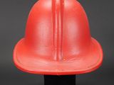 an image of a red fireman ' s helmet on a black surface