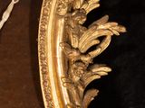 a gold frame with a picture of a man in a tutu