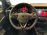 the interior of a car with a steering wheel and dashboard controls