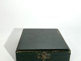 a small green box sitting on top of a white table