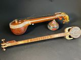 two pieces of musical instruments sitting on top of a black surface
