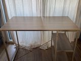 a wooden table with a shelf underneath it on a hard wood floor