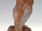 an image of a sculpture of an owl sitting on top of a wooden block