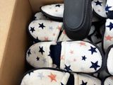 many pairs of slippers in a box on the floor