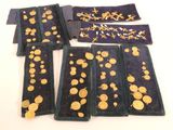 several pieces of cloth with gold coins on them sitting on a table
