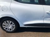 a small white car parked on the side of the road
