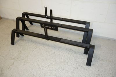 a black bench that is in a room with a white brick wall