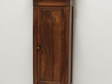 a tall wooden grandfather clock in the corner of a room