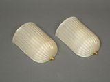 pair of white glass wall sconces with brass fittings