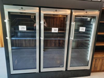three refrigerators that are on display in a store