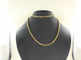 a black mannequin with a gold chain on it