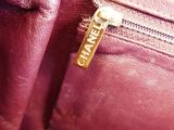 a close up of a purple purse with a tag on it