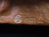 an image of a bronze sculpture of a horse with a medallion on it ' s back