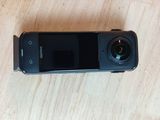 a black cell phone sitting on a wooden table