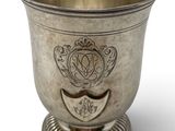 a silver cup that is sitting on a pedestal
