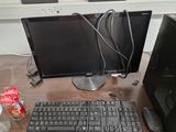 a computer monitor, keyboard and mouse on a desk