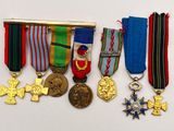 several medals and medals are displayed on a white surface