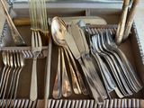 a box with a bunch of silverware in it