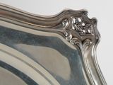 a silver plate with a decorative design on the top of it