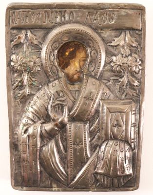 an antique silver plate with a picture of a man holding a book