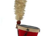 a small red bucket with a feather sticking out of it