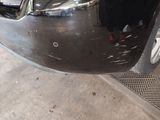 a close up of a car ' s front bumper with a hole in it