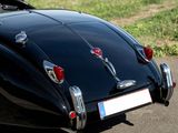 an image of a classic car parked on the side of the road