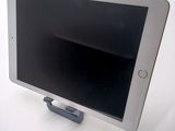 a tablet that is sitting on a stand on a table