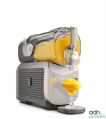 an image of a juicer with a glass of orange juice