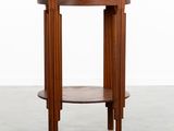 a round wooden table with a shelf on top of it