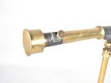 a telescope on a tripod stand with a white background
