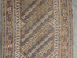 an old rug with a pattern on it sitting on the floor