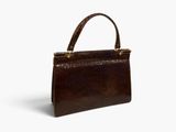 a brown snake skin handbag on a white background