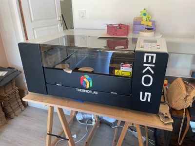 an image of a large printer sitting on top of a wooden table