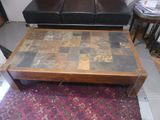 a coffee table that has a tile top on it