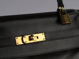 a close up of a black purse with a lock on it