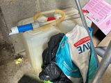 a bag of garbage on the floor next to a mop and a bucket