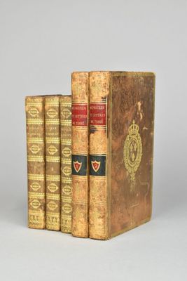 three books sitting on top of each other on a white surface