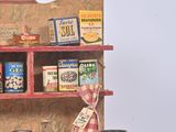 a wooden display case with many different types of tins on it