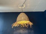 a straw hat hanging from the ceiling of a blue room