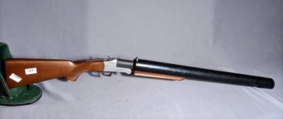 a close up of a rifle on a table with a white background